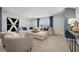 Spacious living room offers plush seating, stylish decor, and large windows for abundant natural light at 2550 Bertrand Way, Cumming, GA 30041