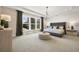 Serene main bedroom with large windows, neutral decor, and a cozy sitting area to enjoy outdoors view at 2550 Bertrand Way, Cumming, GA 30041