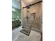 Modern bathroom with a large glass-enclosed shower, updated fixtures, and neutral tile flooring at 321 Roses Creek Dr, Lawrenceville, GA 30044