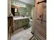 Well-lit bathroom with granite countertops, cabinets and an enclosed tiled shower at 321 Roses Creek Dr, Lawrenceville, GA 30044