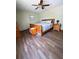 Bedroom with wood floors, ceiling fan, and natural light at 321 Roses Creek Dr, Lawrenceville, GA 30044