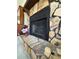 Close-up of a stone fireplace with a teddy bear wearing a love shirt at 321 Roses Creek Dr, Lawrenceville, GA 30044