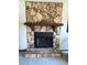 Unique stone fireplace with rustic wooden mantel, creating a cozy focal point at 321 Roses Creek Dr, Lawrenceville, GA 30044