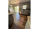 Well-lit kitchen featuring gray cabinets, stainless steel appliances, and access to an outdoor deck at 321 Roses Creek Dr, Lawrenceville, GA 30044