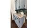 Stylish kitchen details featuring gray cabinets, granite countertops, and herringbone tile backsplash at 321 Roses Creek Dr, Lawrenceville, GA 30044