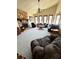 Spacious living room with stone fireplace, ceiling fan, neutral carpet, and natural light from multiple windows at 321 Roses Creek Dr, Lawrenceville, GA 30044