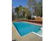Backyard in-ground swimming pool surrounded by patio and landscaping at 321 Roses Creek Dr, Lawrenceville, GA 30044