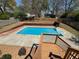 Backyard oasis featuring a sparkling in-ground pool, surrounded by a concrete patio and a well-maintained wooden fence at 321 Roses Creek Dr, Lawrenceville, GA 30044