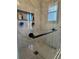 Tiled shower featuring glass doors, shelving, and hexagon tiled floor at 321 Roses Creek Dr, Lawrenceville, GA 30044