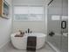 Relaxing bathroom with a freestanding tub, neutral tones, and glass-enclosed shower at 1168 Mado Loop, Chattahoochee Hills, GA 30268
