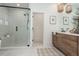 Bright bathroom featuring a glass-enclosed shower, tile floor, and double vanity at 1168 Mado Loop, Chattahoochee Hills, GA 30268