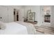Bright bedroom featuring hardwood floors, modern decor, and a hallway view to the bathroom at 1168 Mado Loop, Chattahoochee Hills, GA 30268