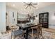 Elegant dining room featuring a modern light fixture, black table, and decorative rug at 1168 Mado Loop, Chattahoochee Hills, GA 30268