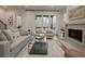 Inviting living room with large windows, comfortable seating, a fireplace, and unique wooden floors at 1168 Mado Loop, Chattahoochee Hills, GA 30268