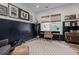 Stylish home office featuring dark wainscoting, gallery wall, and a large window for natural light at 1168 Mado Loop, Chattahoochee Hills, GA 30268