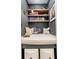 Cozy reading nook featuring built-in bookshelves, soft lighting, and a comfortable cushioned bench at 1168 Mado Loop, Chattahoochee Hills, GA 30268