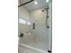 Modern shower with glass doors, light grey tiled walls, and built-in bench at 1168 Mado Loop, Chattahoochee Hills, GA 30268