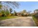 Large backyard featuring a concrete parking pad, a wooden privacy fence, and established trees at 1420 Elizabeth Ln, East Point, GA 30344