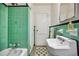 Charming bathroom boasting vintage green tile, classic fixtures, and a patterned floor at 1420 Elizabeth Ln, East Point, GA 30344