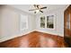 Comfortable bedroom features hardwood floors, a ceiling fan, and sun-filled windows at 1420 Elizabeth Ln, East Point, GA 30344
