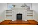 Elegant fireplace with decorative mantle and flanking built-in shelves at 1420 Elizabeth Ln, East Point, GA 30344
