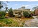 Charming single-story home featuring an inviting front yard with mature trees and a stone walkway at 1420 Elizabeth Ln, East Point, GA 30344