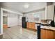 This kitchen features tile floor, butcher block counters, stainless steel dishwasher, and adjacent eat-in area at 1420 Elizabeth Ln, East Point, GA 30344