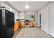 Traditional kitchen with tile floors, wood cabinets, stainless steel oven, and black refrigerator at 1420 Elizabeth Ln, East Point, GA 30344