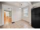 Eat in kitchen with black fridge, pendant light, neutral paint, and view to front rooms at 1420 Elizabeth Ln, East Point, GA 30344