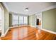 Spacious living room features hardwood floors and three large windows allowing for an abundance of natural light at 1420 Elizabeth Ln, East Point, GA 30344