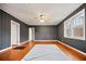 Inviting living room features wood-paneled walls, ceiling fan, and a large window for natural light at 1420 Elizabeth Ln, East Point, GA 30344
