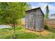 Rustic shed in backyard with double doors, providing extra storage space at 1420 Elizabeth Ln, East Point, GA 30344