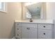 Bathroom features modern vanity with quartz countertops, large mirror, and sleek black hardware at 2620 Oak St, Atlanta, GA 30344