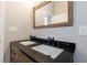 Bathroom features a dual sink vanity with granite countertop, and a rustic-framed mirror at 2620 Oak St, Atlanta, GA 30344
