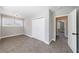 Bedroom featuring large closet doors, plush carpeting, and two sun-filled windows at 2620 Oak St, Atlanta, GA 30344