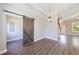 Dining area features wood floors, modern lighting, and a rustic barn door, blending style with functionality and charm at 2620 Oak St, Atlanta, GA 30344