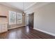 Dining area featuring wood floors, a modern light fixture, and a rustic sliding barn door, leading to another room at 2620 Oak St, Atlanta, GA 30344