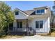 Charming home featuring a covered porch, gray trim, and a well-manicured lawn at 2620 Oak St, Atlanta, GA 30344