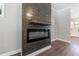 Modern fireplace framed by wood with a view into the kitchen at 2620 Oak St, Atlanta, GA 30344