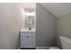 Small half-bathroom with updated vanity, dark hardware and a toilet at 2620 Oak St, Atlanta, GA 30344