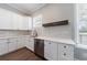 White kitchen with light backsplash, stainless appliances, white countertop, and dark fixtures provides a clean, modern aesthetic at 2620 Oak St, Atlanta, GA 30344