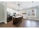 Bright kitchen features white cabinets, stainless appliances, and a center island with wood floors and modern lighting at 2620 Oak St, Atlanta, GA 30344