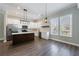 Open kitchen boasts white cabinets, stainless appliances, a center island, and wood floors, creating an inviting space at 2620 Oak St, Atlanta, GA 30344