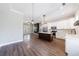 Open floor plan with a modern kitchen, a center island with white countertop, and wood floors throughout the living space at 2620 Oak St, Atlanta, GA 30344