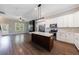 The spacious kitchen with white cabinets, a center island, stainless appliances, and modern lighting has a welcoming atmosphere at 2620 Oak St, Atlanta, GA 30344