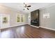 Bright living room with hardwood floors, a fireplace, and large windows overlooking the backyard at 2620 Oak St, Atlanta, GA 30344