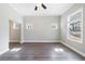 Living room with hardwood floors, large windows, and modern ceiling fan at 2620 Oak St, Atlanta, GA 30344
