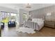 Bright bedroom featuring a stylish bed, paneled accent wall, and lots of natural light from large windows at 312 Concord St, Alpharetta, GA 30009