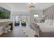Serene bedroom with plush chairs, a modern media console, and large windows offering a scenic view at 312 Concord St, Alpharetta, GA 30009