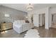 Spacious bedroom featuring a beautifully upholstered bed, elegant decor, and a neutral color palette at 312 Concord St, Alpharetta, GA 30009